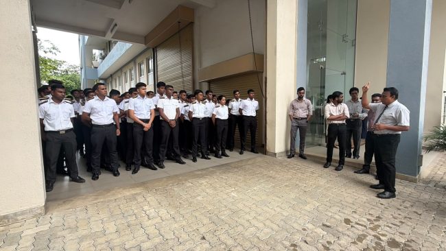 Students and staff gathered at the assembly area during the emergency fire drill Students and staff gathered at the assembly area during the emergency fire drill
